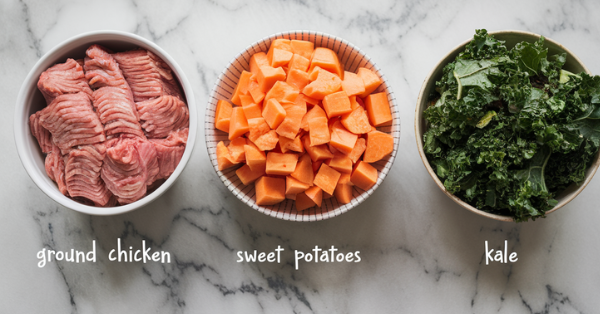 Three primary ingredients (ground chicken, chopped sweet potatoes, and kale) placed side by side on a marble counter, each neatly arranged with small labels for clarity.