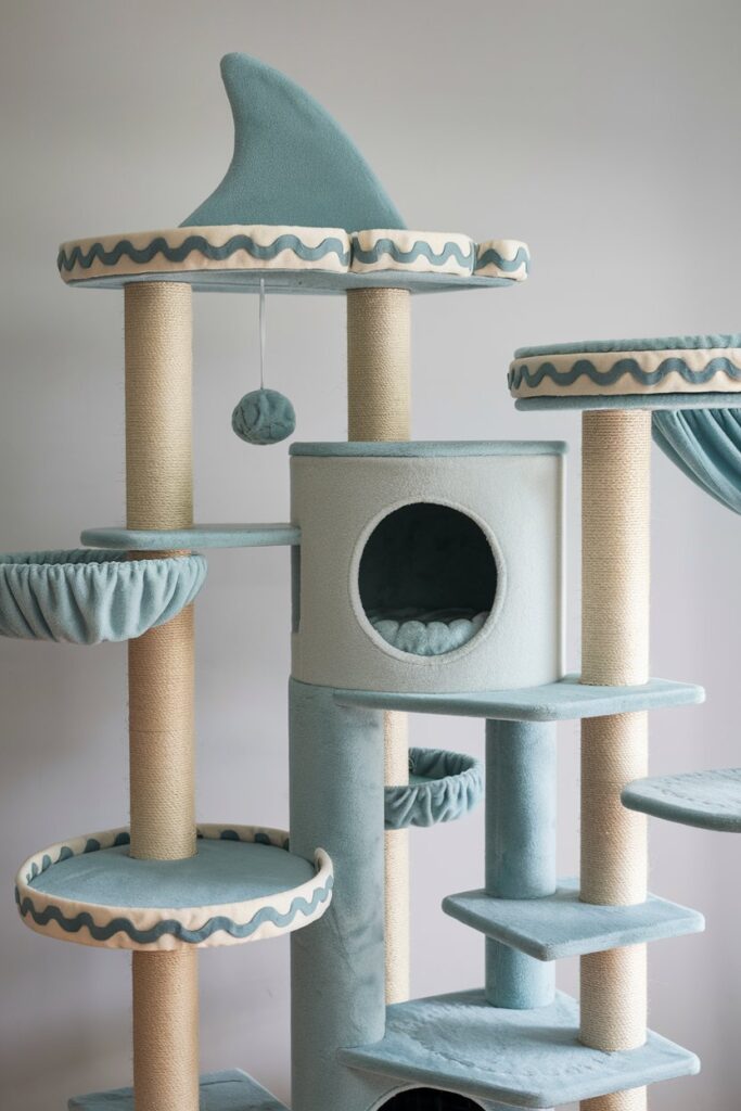 Shark-themed cat condo tower with multiple levels, a circular hammock, and wavy platform edges.