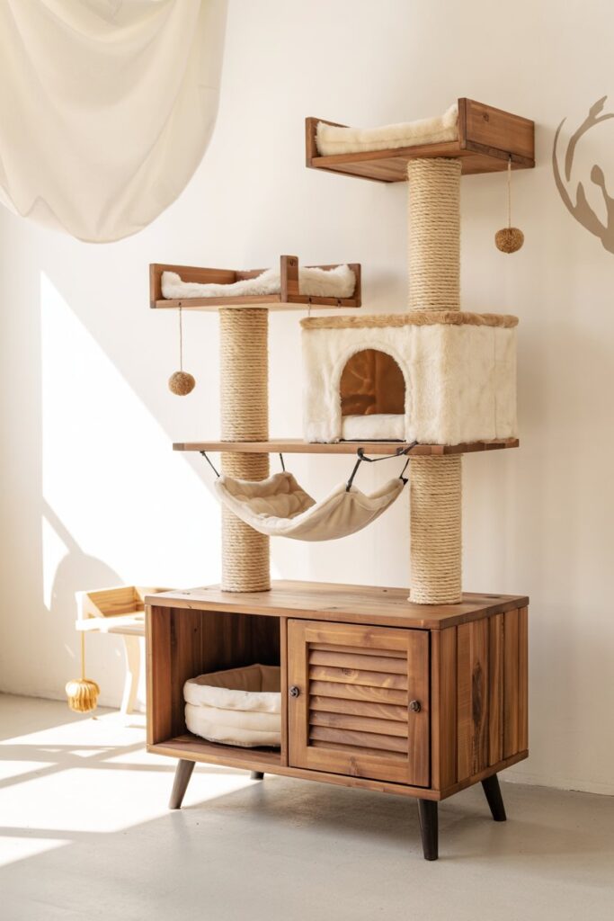 Multi-level rustic cat tree with sisal scratching posts, plush hammock, and hanging pom-pom toys—perfect indoor cat condo