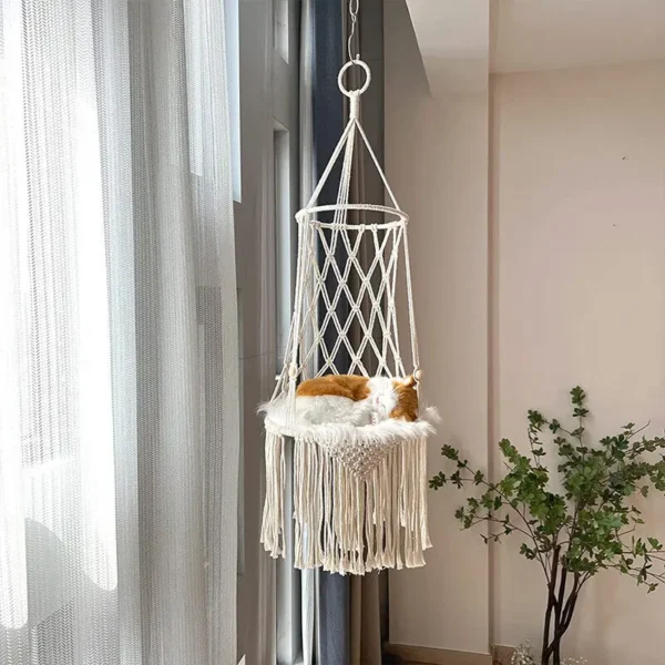 Handcrafted macrame pet hammock displayed with natural light and indoor plants