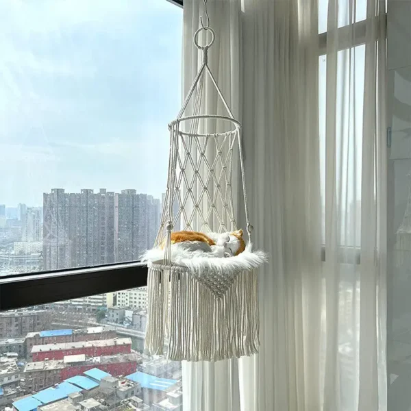 Woven macrame pet hammock for cats and small dogs, suspended near a window