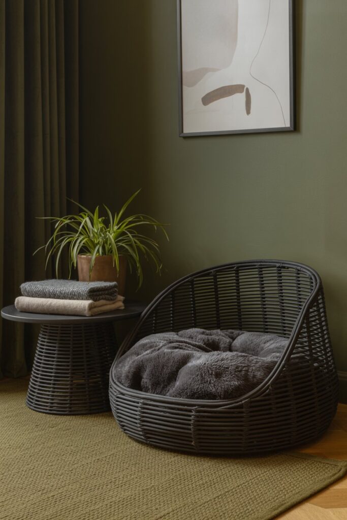 Designer-inspired pet nook with black rattan furniture and moody home decor accents.